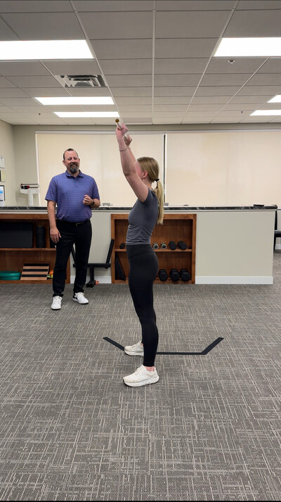 Dr. Carter performing rehab exercises with a high school athlete in Buffalo MN