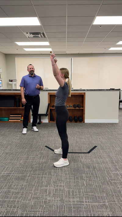 Dr. Carter performing rehab exercises with a high school athlete in Buffalo MN