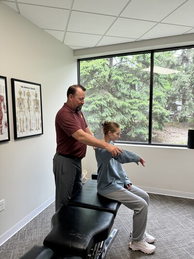 Dr. Carter performing soft tissue work on a patient at InMotion Chiropractic
