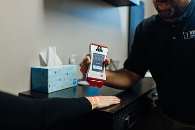 Dr. Carter performing cold laser on a patient at InMotion Chiropractic